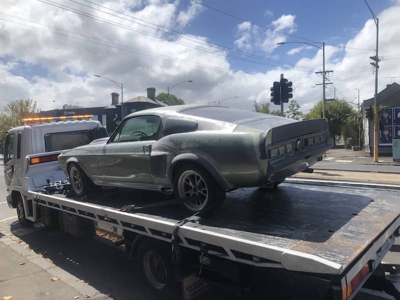 Towing a mustang on a tilt tray truck from Fast Lalor Towing