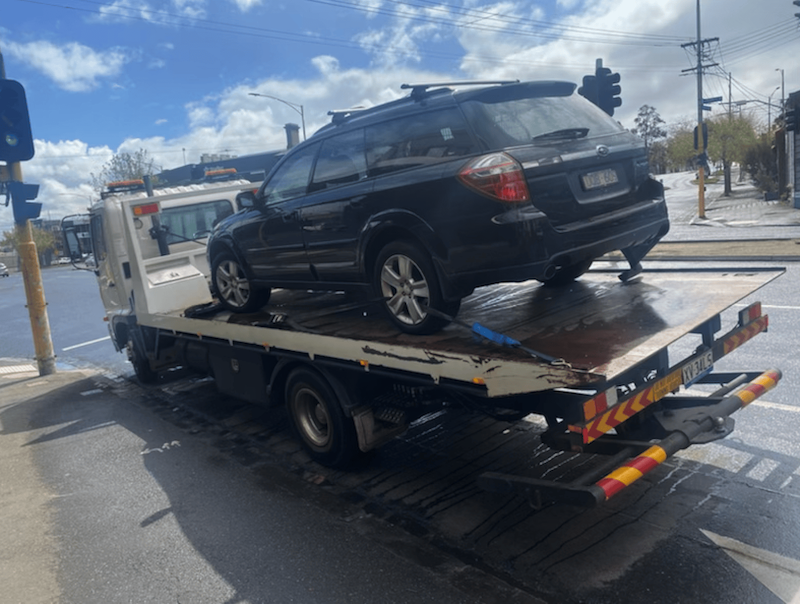 A tilt tray truck towing a wagon near Lalor Melbourne.